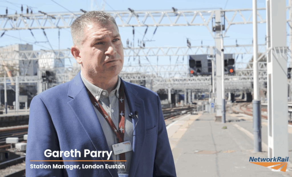 Gareth Parrey, Euston Station Manager, stood on the platform facing the camera for interview