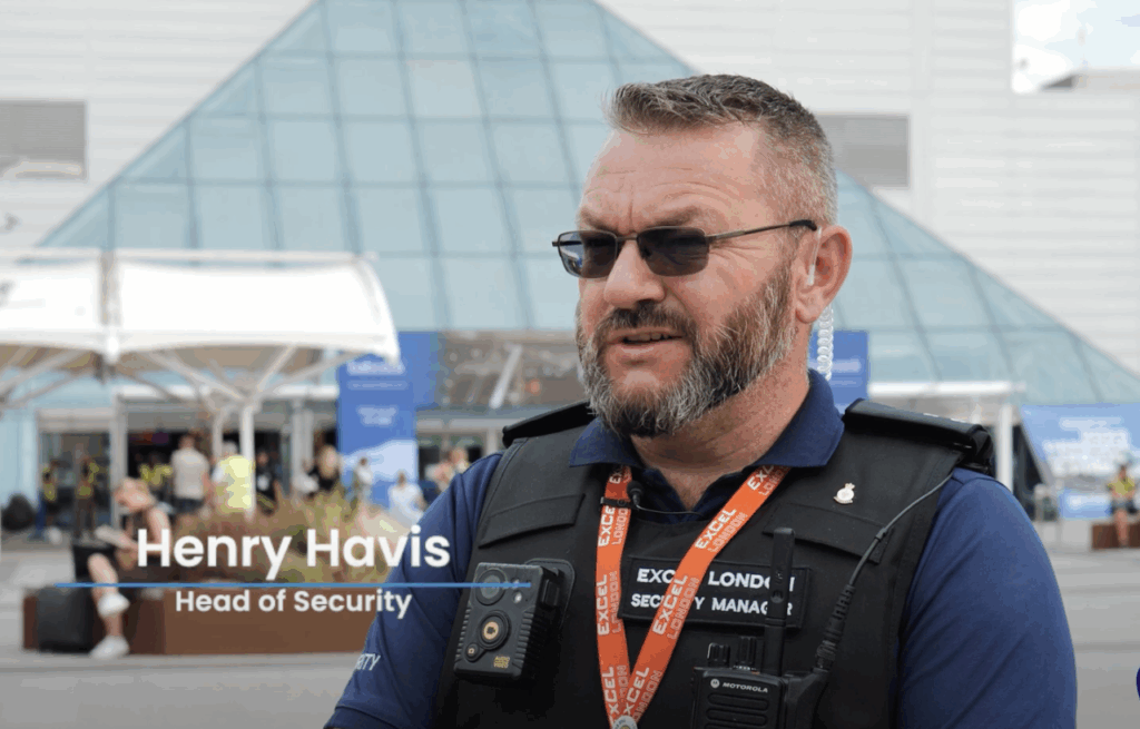 Henry Havis, Head of Security at Excel London, standing in front of Excel London and facing the camera for interview