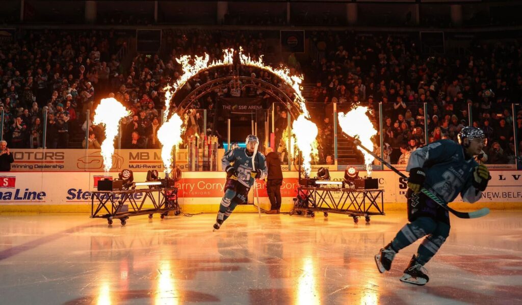 2 Ice hockey skaters skating onto the )2 Belfast rink